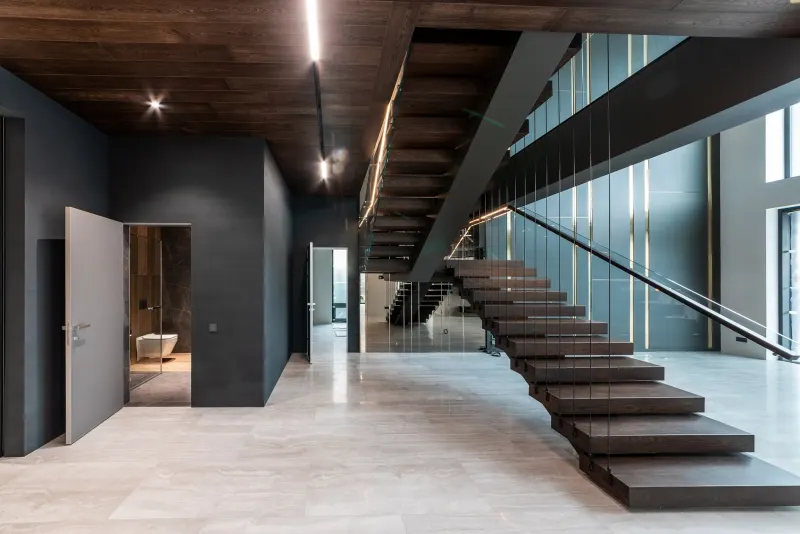 Concrete and glass stairwell with open timber treads